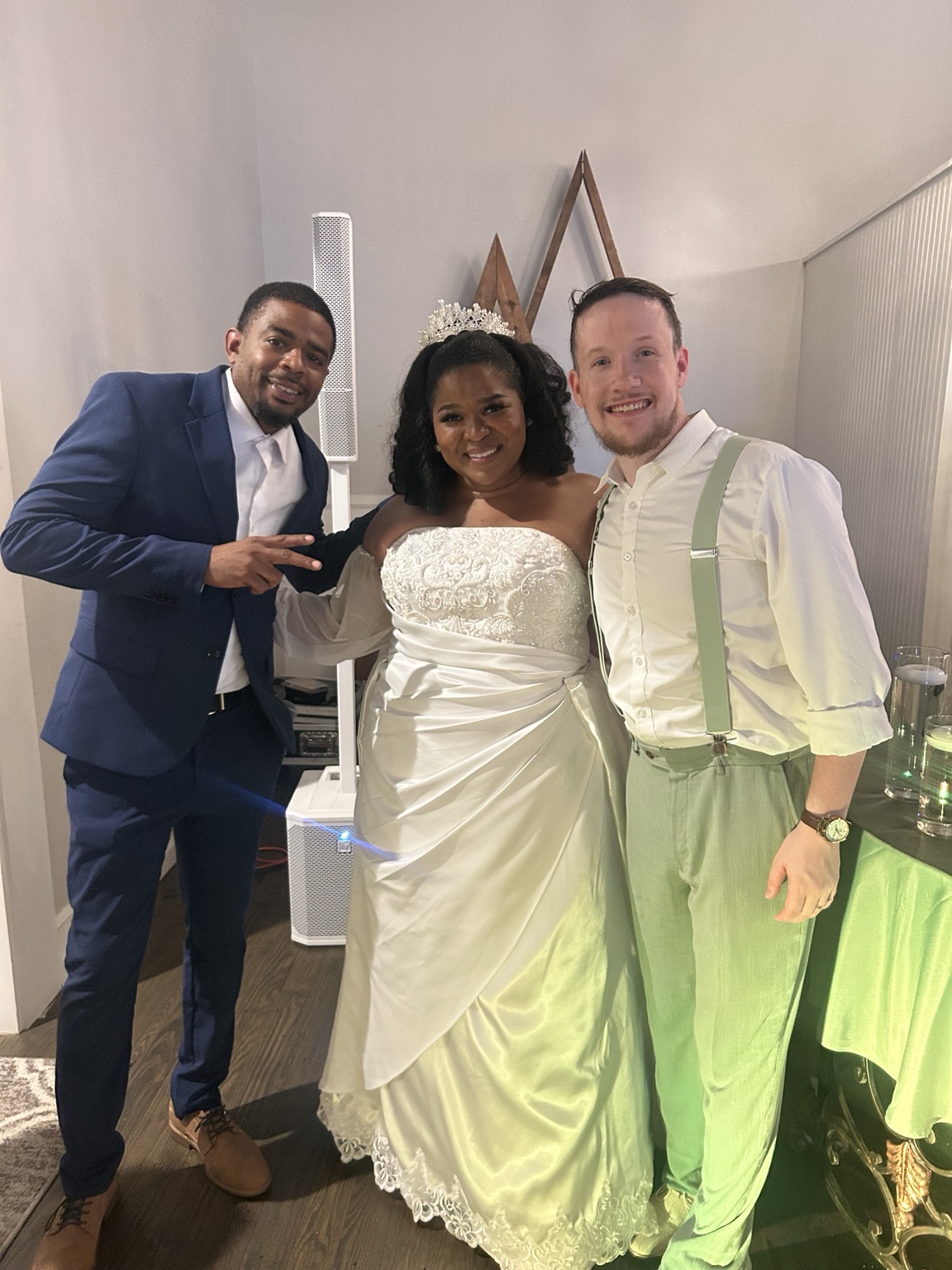 DJ Battio with a couple at a wedding celebration